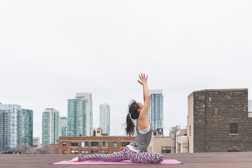 woman doing yoga at the rooftop