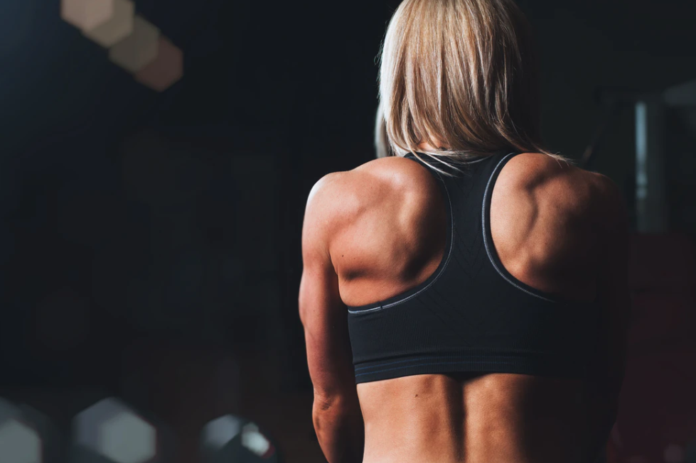 muscular woman's back and shoulders for P 90 x3 review